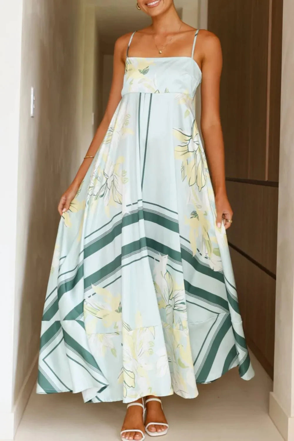 Printed square neck cami maxi dress from Trendsi featuring a flowing silhouette and vibrant floral pattern.