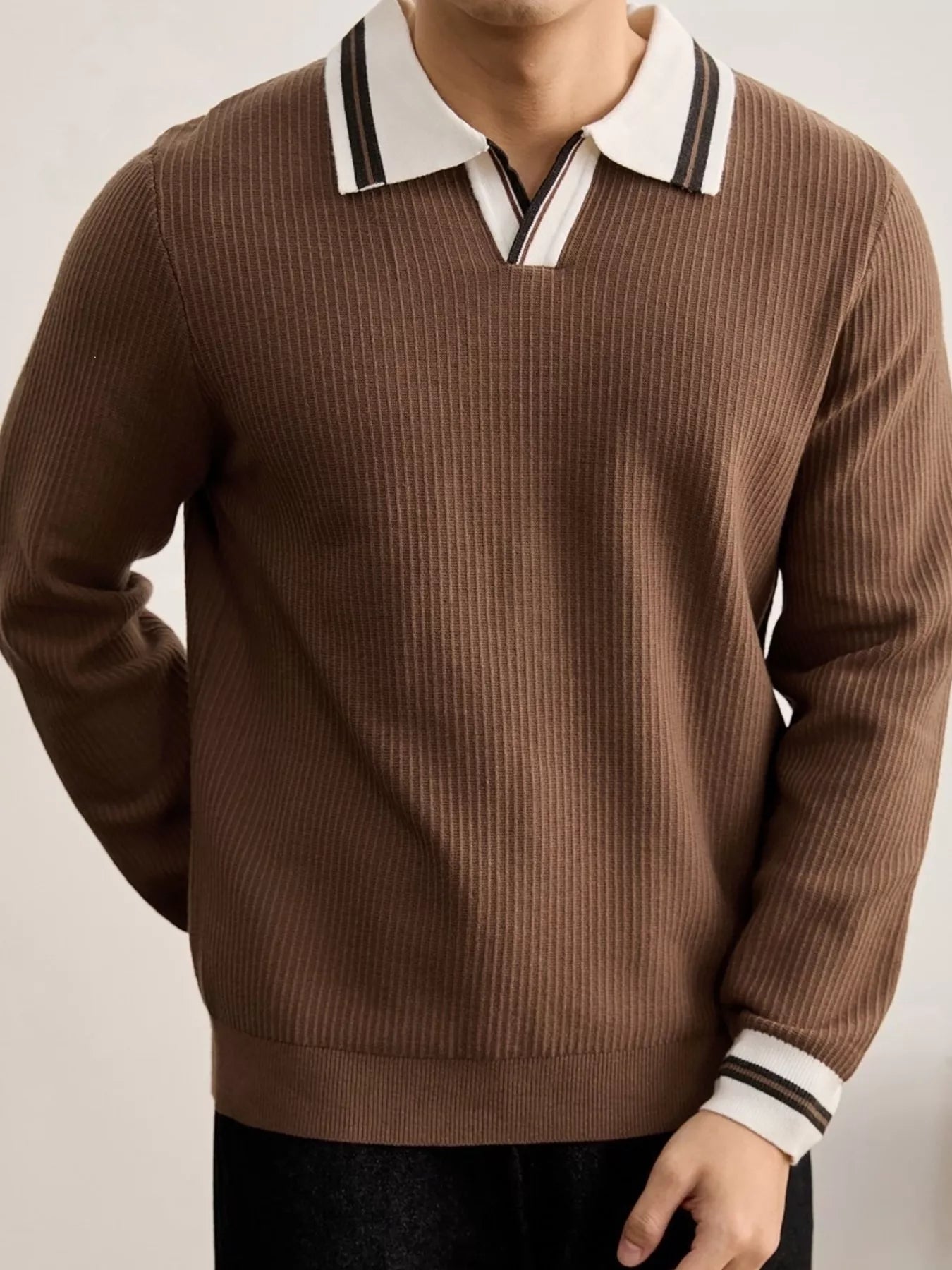 Men's plus size black ribbed knit sweater with contrast trim polo collar by Trendsi, showcasing the detailed collar and textured fabric.