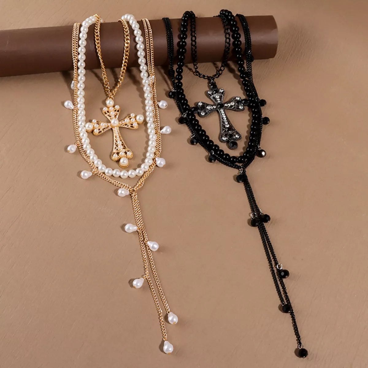 Three-piece pearl cross pendant necklace set featuring elegant jewelry from Trendsi, with detailed pearl and cross designs.