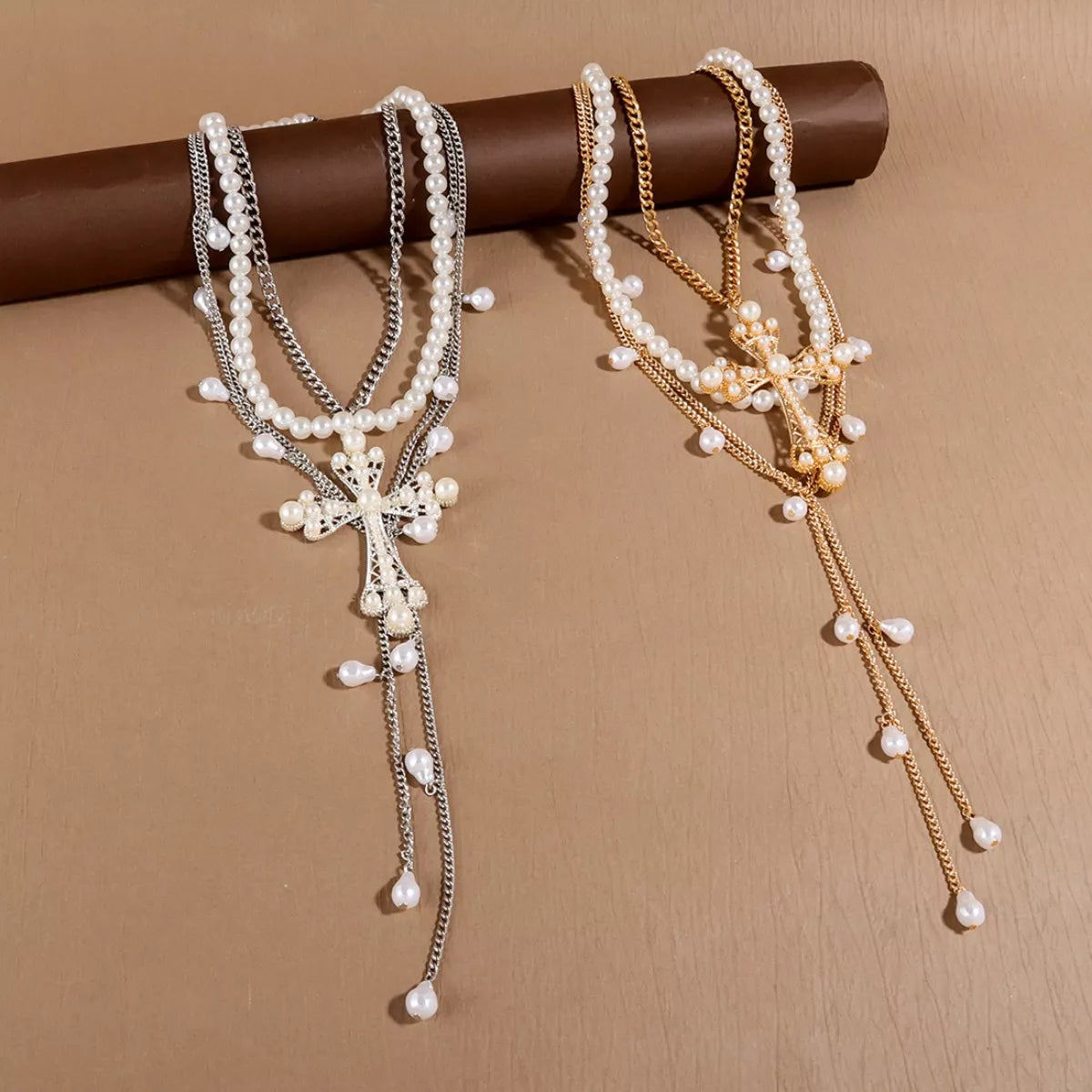 Three-piece pearl cross pendant necklace set by Trendsi featuring elegant pearl and cross designs on gold-tone chains