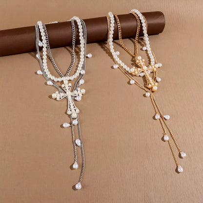 Three-piece pearl cross pendant necklace set by Trendsi featuring elegant pearl and cross designs on gold-tone chains