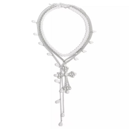 Three-piece set of pearl cross pendant necklaces by Trendsi featuring elegant pearl and cross designs on silver chains