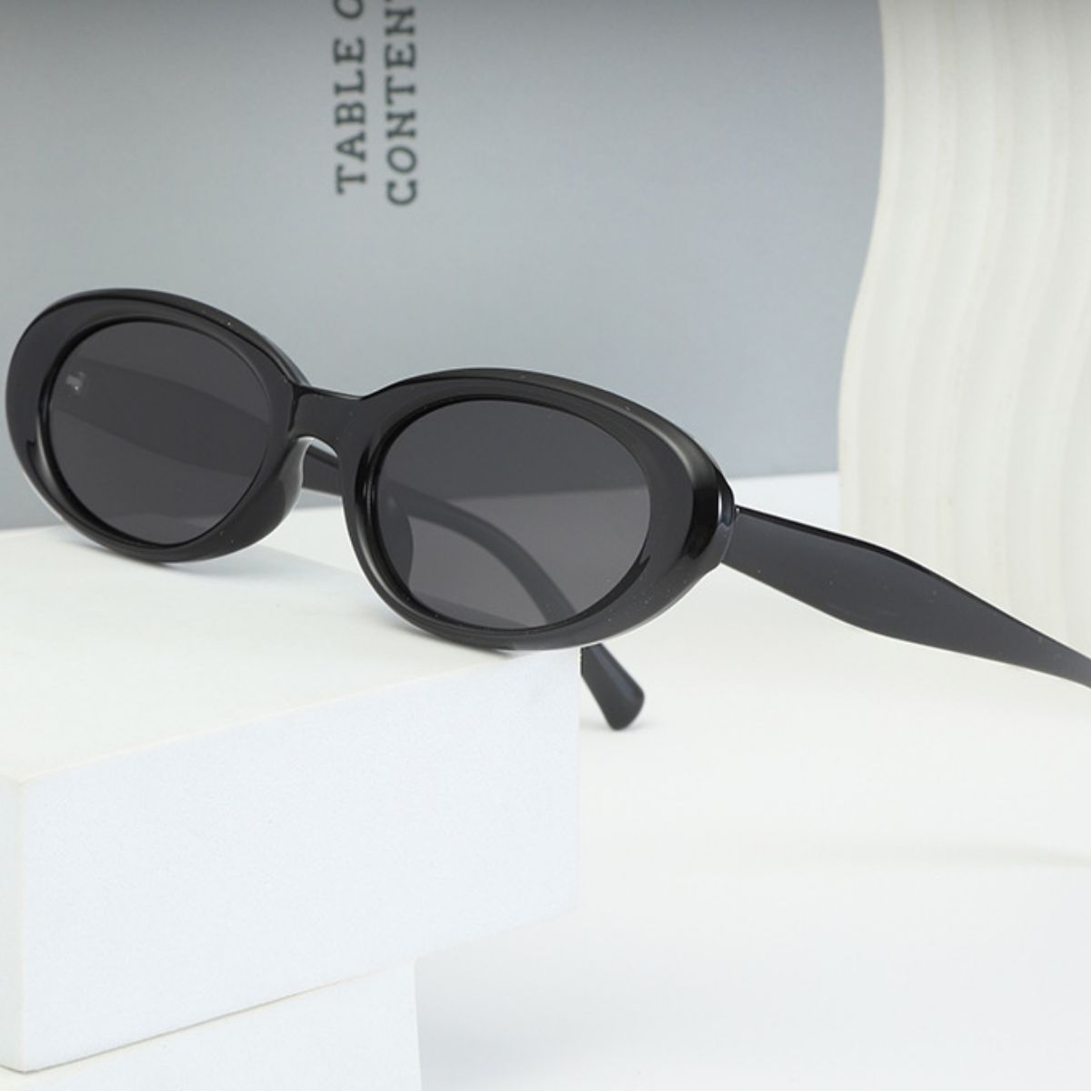 Trendsi UV protection oval sunglasses with black frames and dark tinted lenses, stylish eyewear for sun protection.