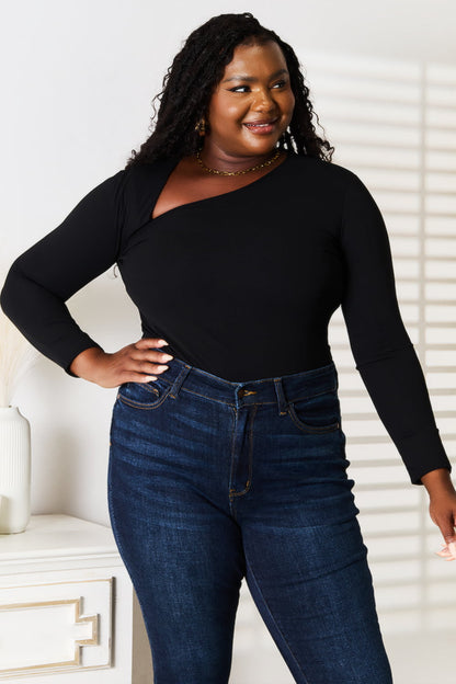Black basic Bae asymmetrical neck long sleeve top by Trendsi, showcasing its unique neckline and fitted design.