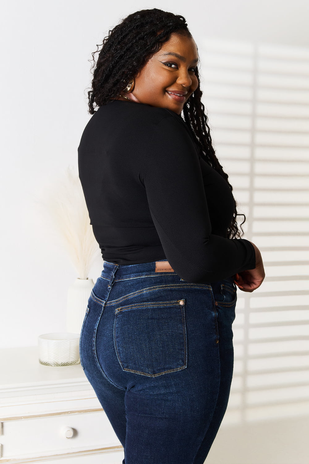Black Basic Bae asymmetrical neck long sleeve top from Trendsi, featuring a stylish neckline and fitted long sleeves.