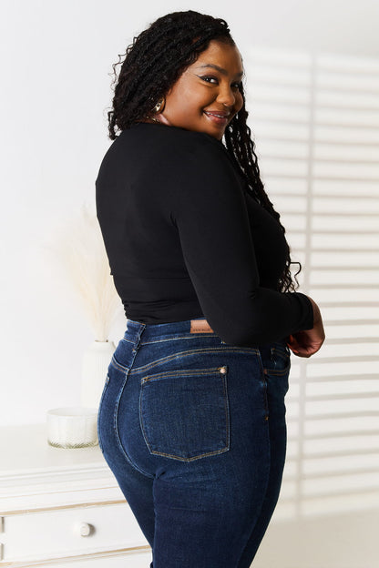 Black Basic Bae asymmetrical neck long sleeve top from Trendsi, featuring a stylish neckline and fitted long sleeves.