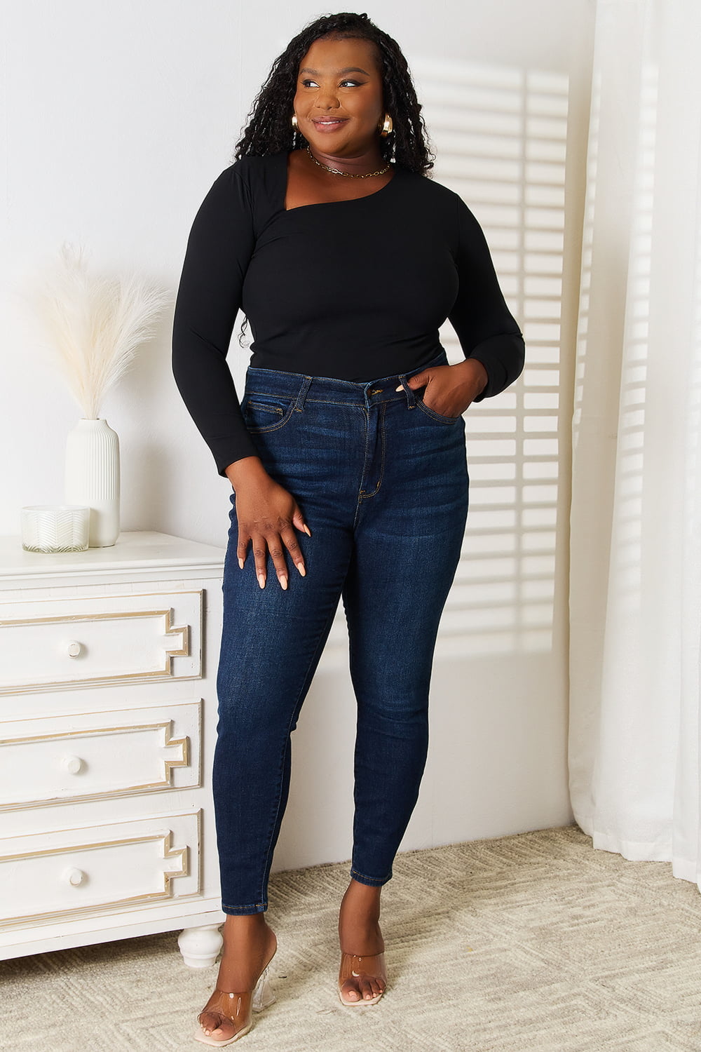 Black Basic Bae asymmetrical neck long sleeve top by Trendsi, showcasing its stylish neckline and fitted design.
