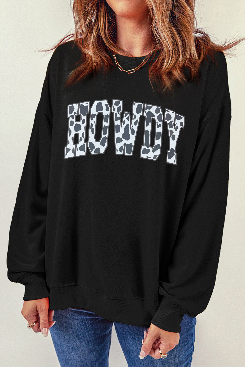 Black Trendsi casual sweatshirt with a round neck and long sleeves featuring a "Howdy" graphic design, perfect for everyday wear.