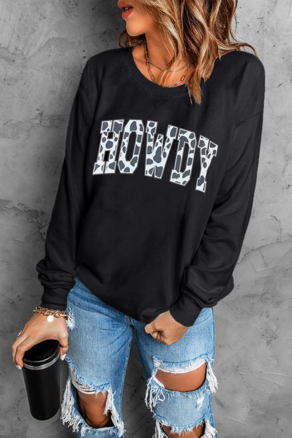 Black Trendsi casual sweatshirt with round neck and long sleeves featuring a "Howdy" graphic for everyday wear.