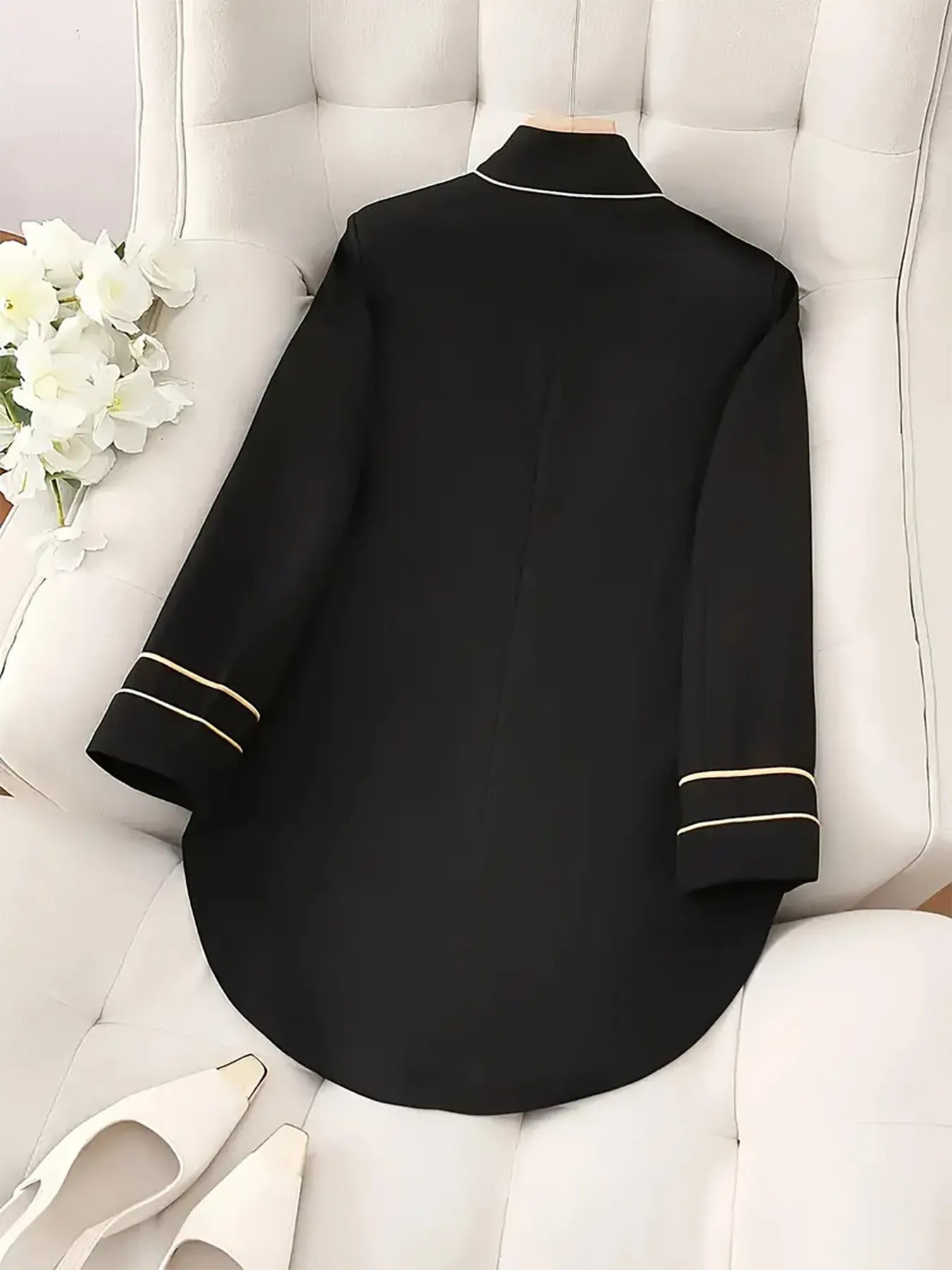 Decorative button high-low blazer with cuff trim from Trendsi, featuring a stylish design and contrasting details.