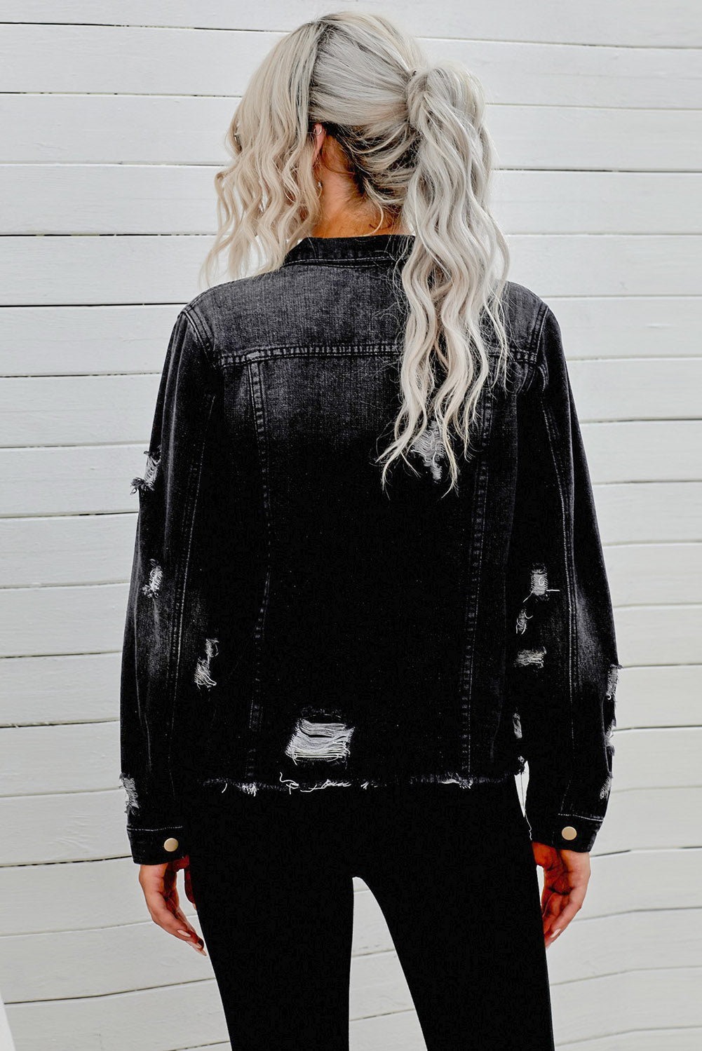 Black distressed raw hem denim jacket with button closures from Trendsi, showcasing a trendy, casual style.
