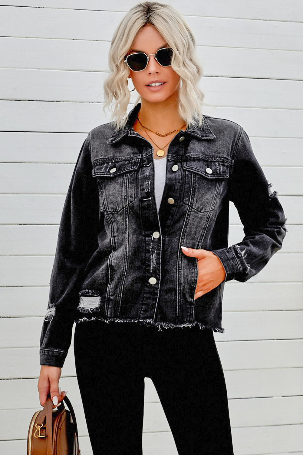 Black distressed raw hem button denim jacket by Trendsi, featuring classic design and raw hem detailing.