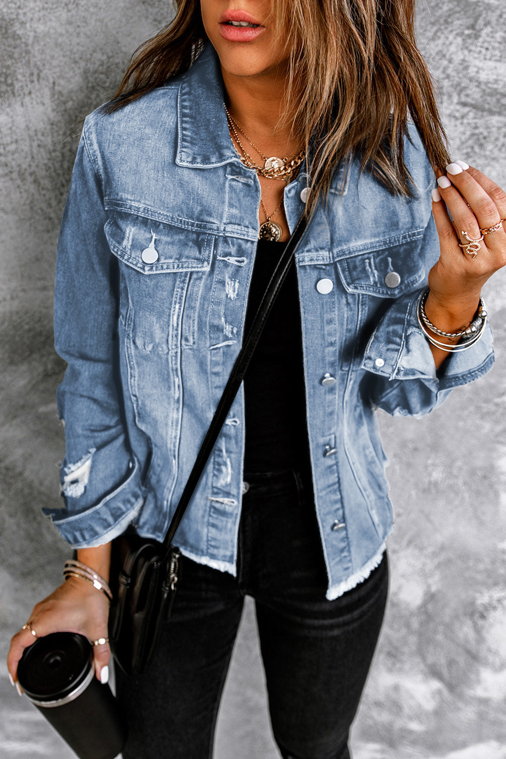 Black distressed raw hem denim jacket with button closure from Trendsi, featuring a casual, rugged style and classic fit.