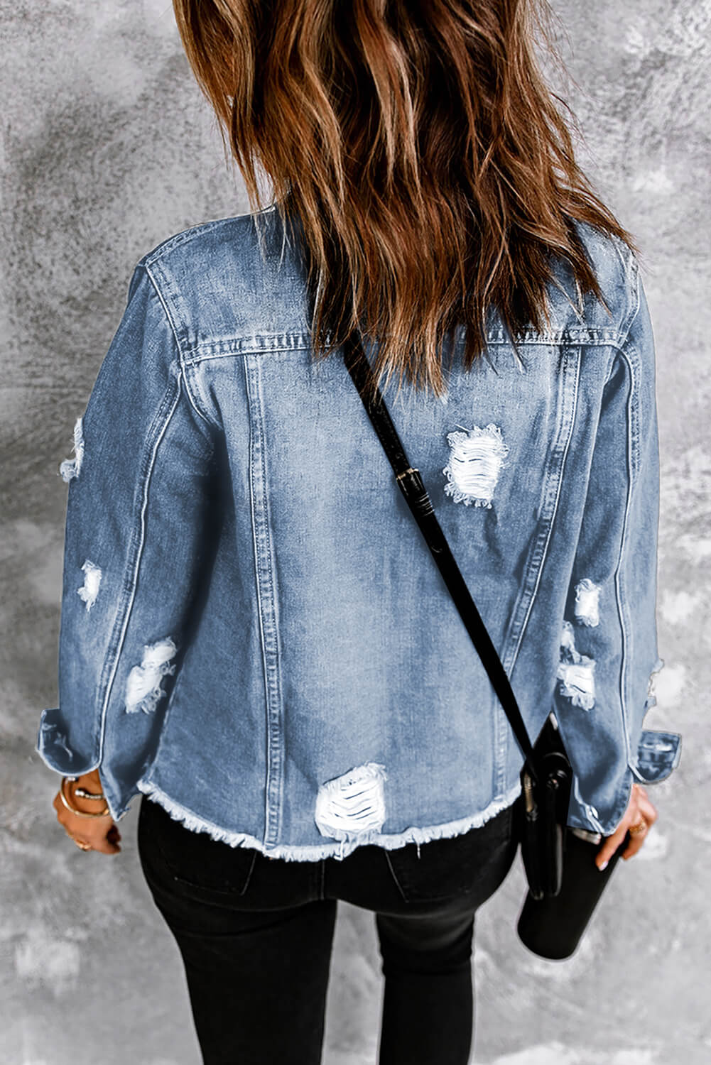 Black distressed raw hem denim jacket with button closures from Trendsi, featuring a classic casual style.