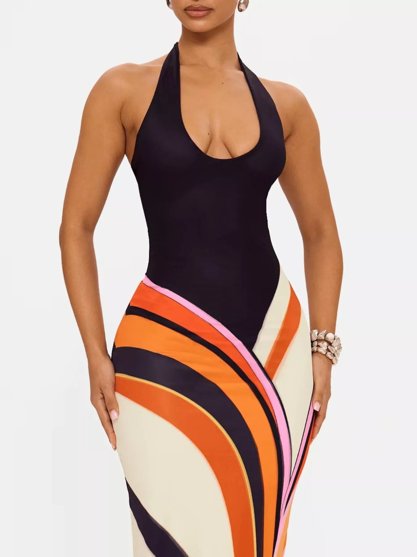 Black halter neck maxi dress by Trendsi featuring an abstract print, flowy silhouette, and elegant design for summer occasions.