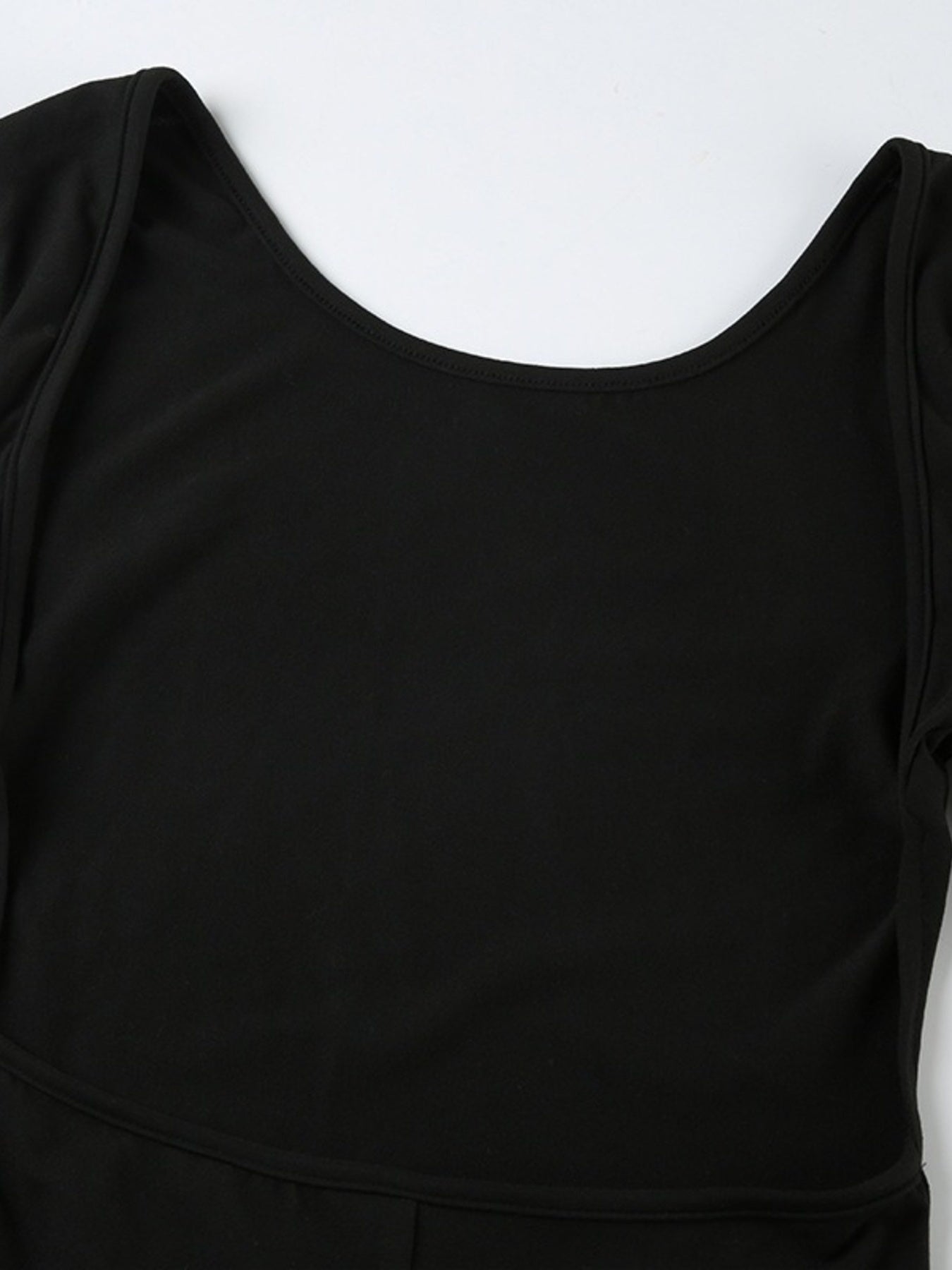 Black long sleeve ruched active romper by Trendsi, featuring a fitted design and stretchy fabric for comfortable wear.