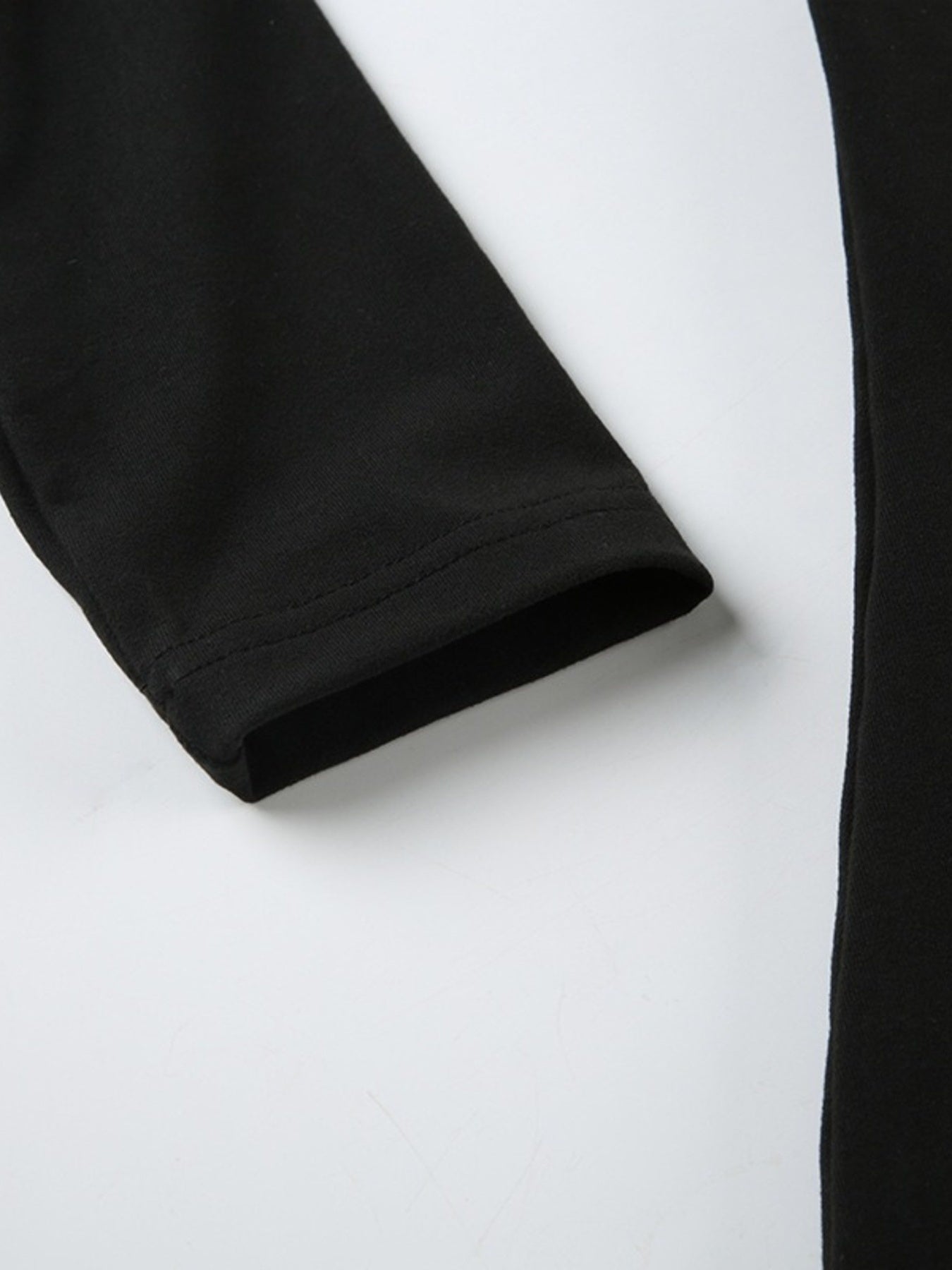 Black long sleeve ruched active romper by Trendsi, featuring a fitted design and stretchy fabric for comfortable active wear.