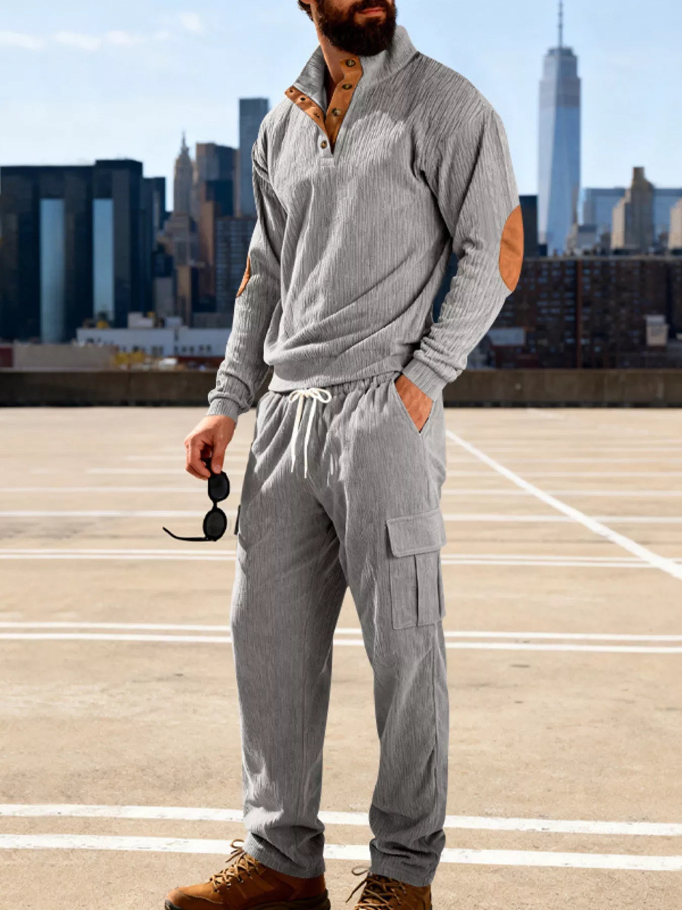 Plus size men's casual black button-detail top and pants set by Trendsi, featuring a relaxed fit and comfortable fabric.
