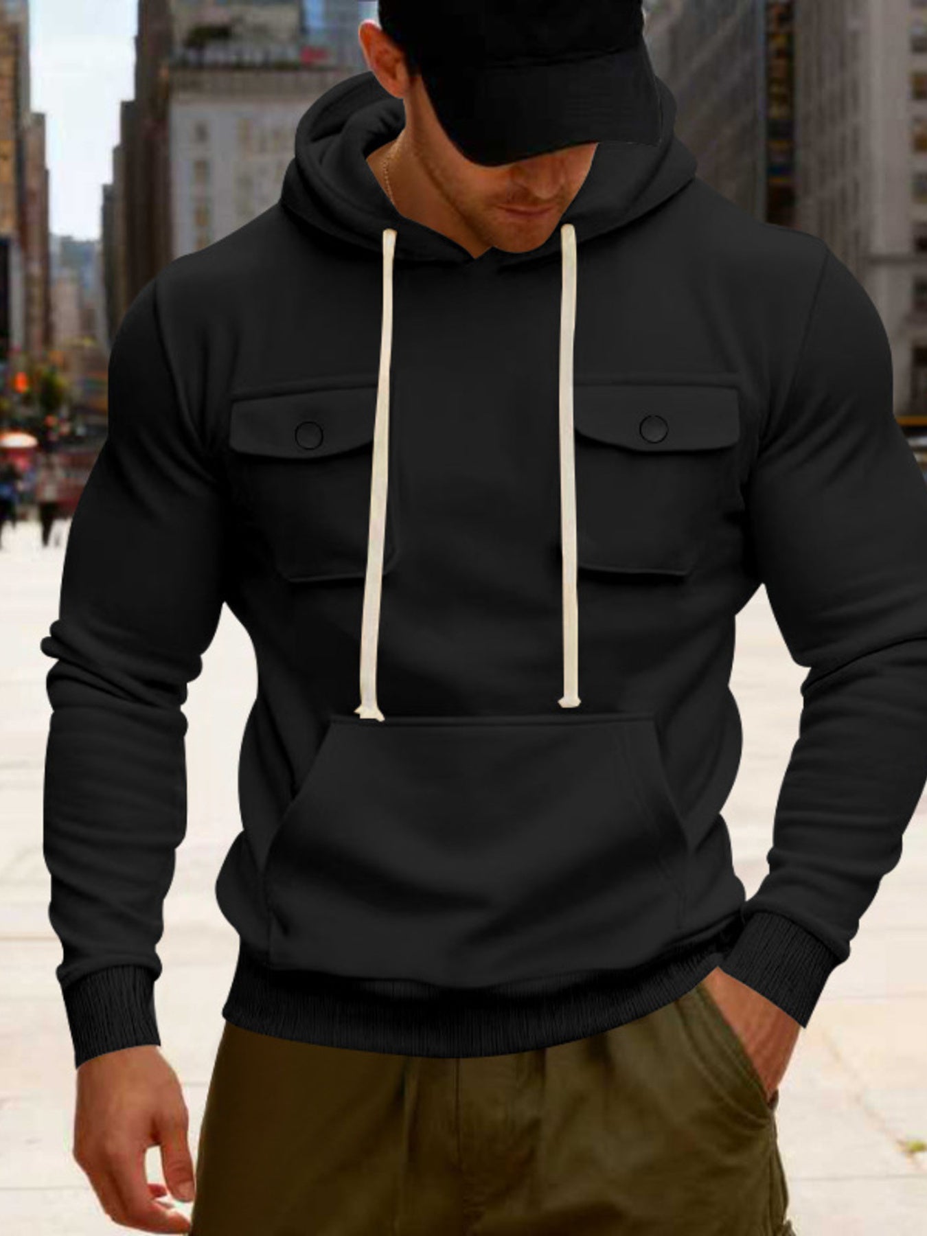 Men's black full-size fleece hoodie with dual chest pockets, cozy and comfortable, from Trendsi.