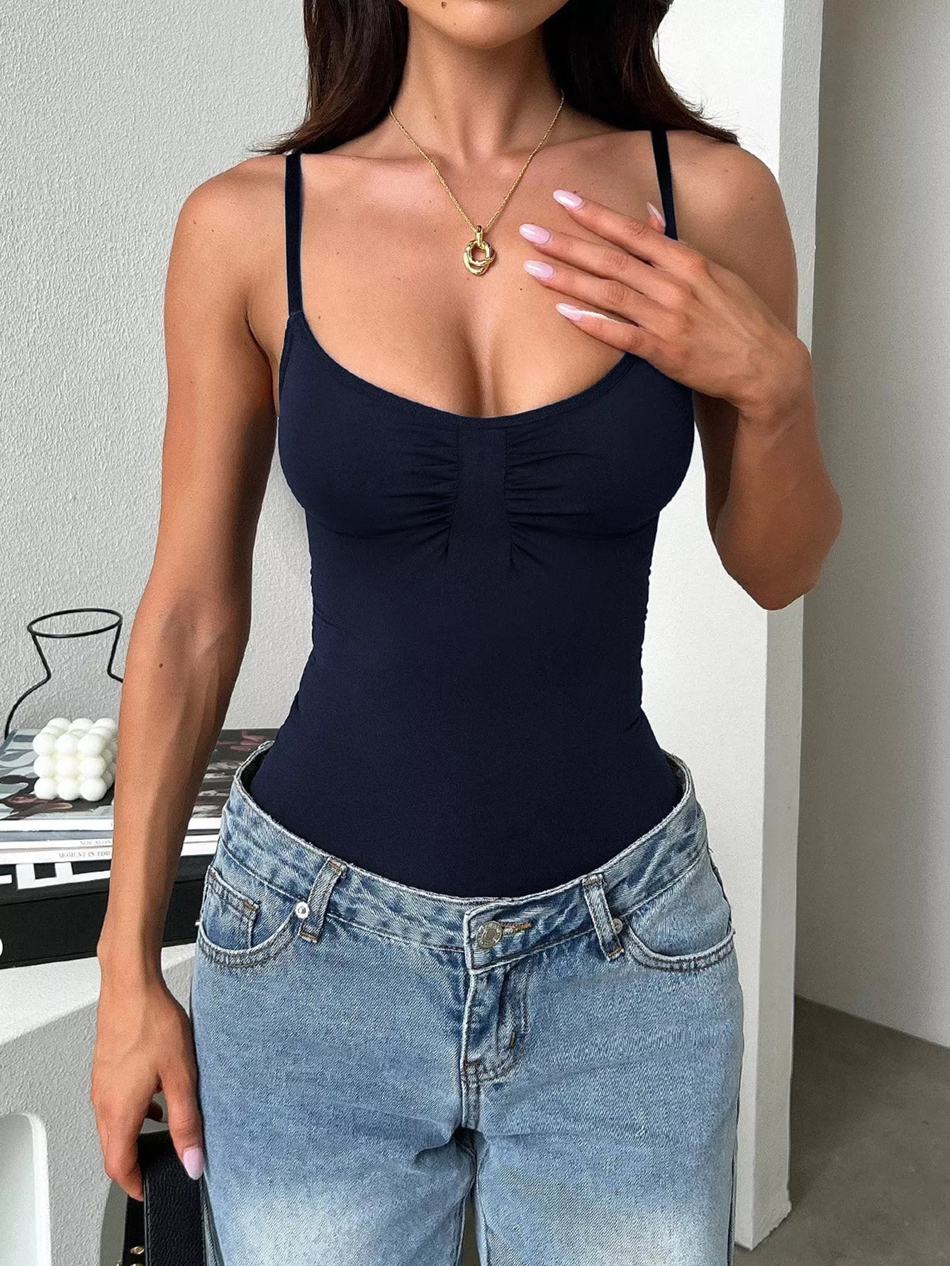Black scoop neck cami from Trendsi, featuring a fitted design and thin straps, ideal for layering or casual wear.