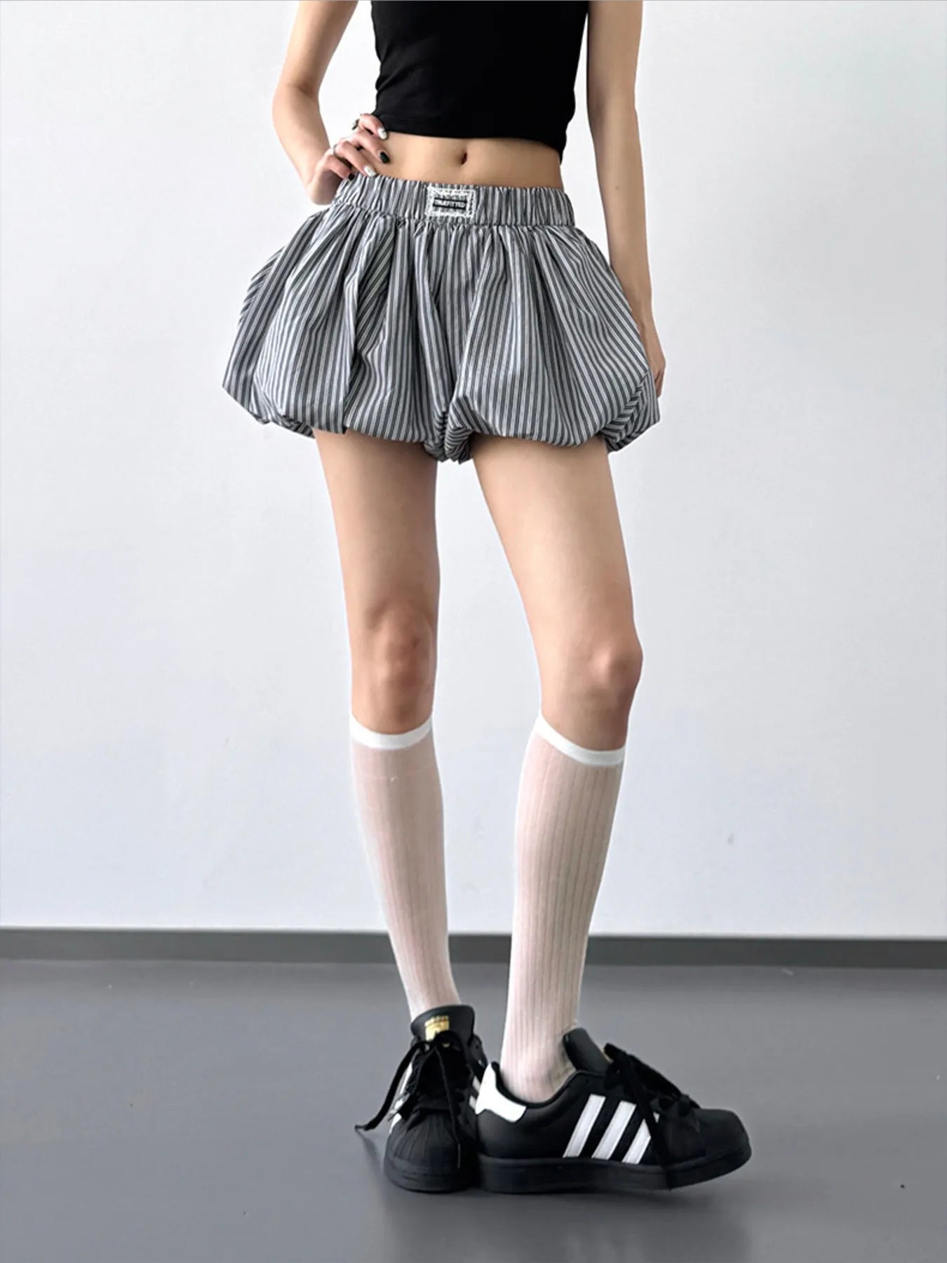 Striped bubble hem casual shorts from Trendsi featuring a relaxed fit and colorful horizontal stripes.