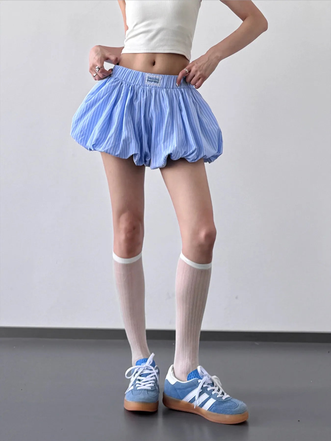 Striped bubble hem casual shorts by Trendsi with relaxed fit, featuring colorful horizontal stripes and a stylish bubble hem design.
