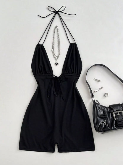 Black tied front halter neck romper by Trendsi, featuring a stylish halter design and comfortable fit, perfect for summer wear.
