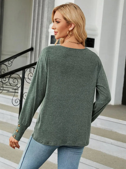 Black V-neck long sleeve T-shirt from Trendsi, shown on a mannequin, featuring a fitted style and soft fabric.