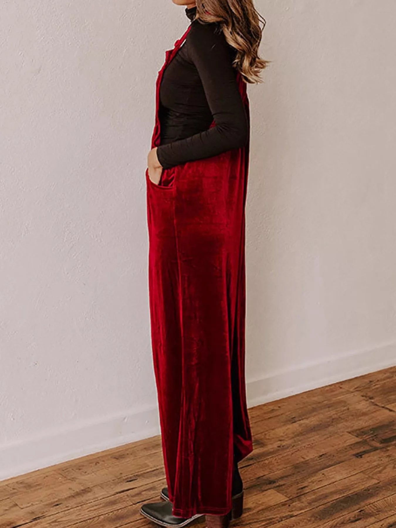Velvet wide-leg overalls in rich fabric, featuring adjustable straps and a relaxed fit, styled with a casual top.