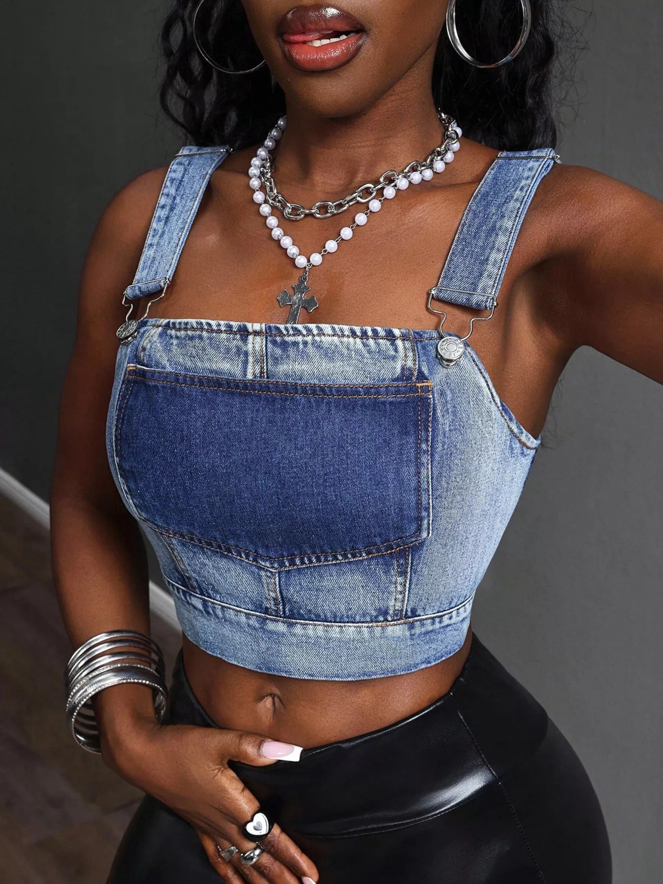 Blue cropped denim top with adjustable straps from Trendsi, featuring a stylish, casual fit and classic denim texture.