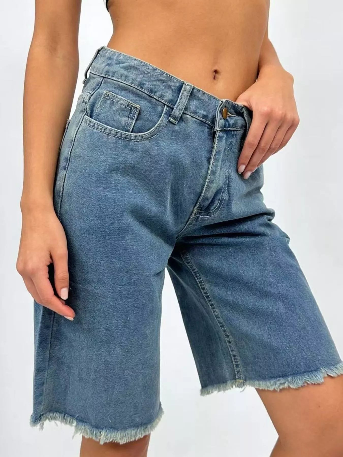 Blue frayed hem relaxed fit denim shorts by Trendsi, showing casual style and distressed detail on lightweight denim fabric.