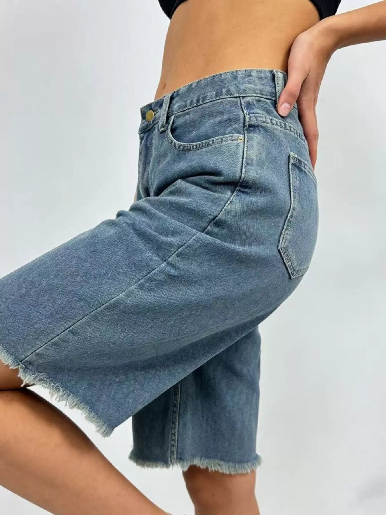 Light blue frayed hem relaxed fit denim shorts by Trendsi, showcasing casual style and distressed denim details.