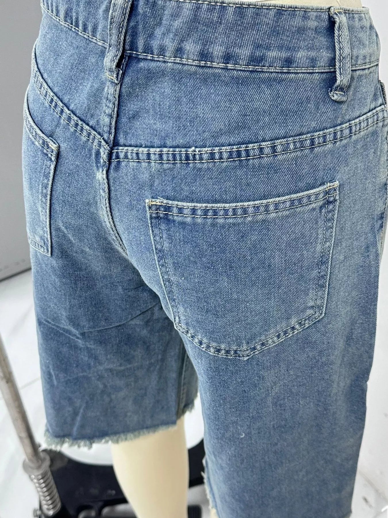 Blue Trendsi frayed hem relaxed fit denim shorts with distressed detailing and casual style, perfect for warm weather.