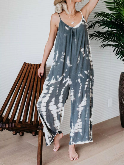 Plus size tie-dye wide-leg jumpsuit by Trendsi, full size, featuring vibrant blue tie-dye pattern and relaxed fit.