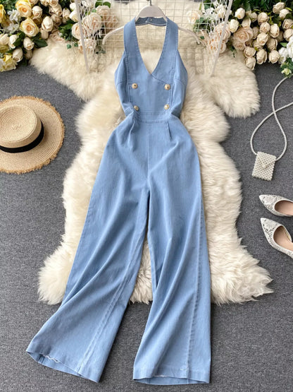 Halter neck wide leg denim jumpsuit by Trendsi featuring a fitted bodice and flowing wide leg pants for a stylish, casual look.