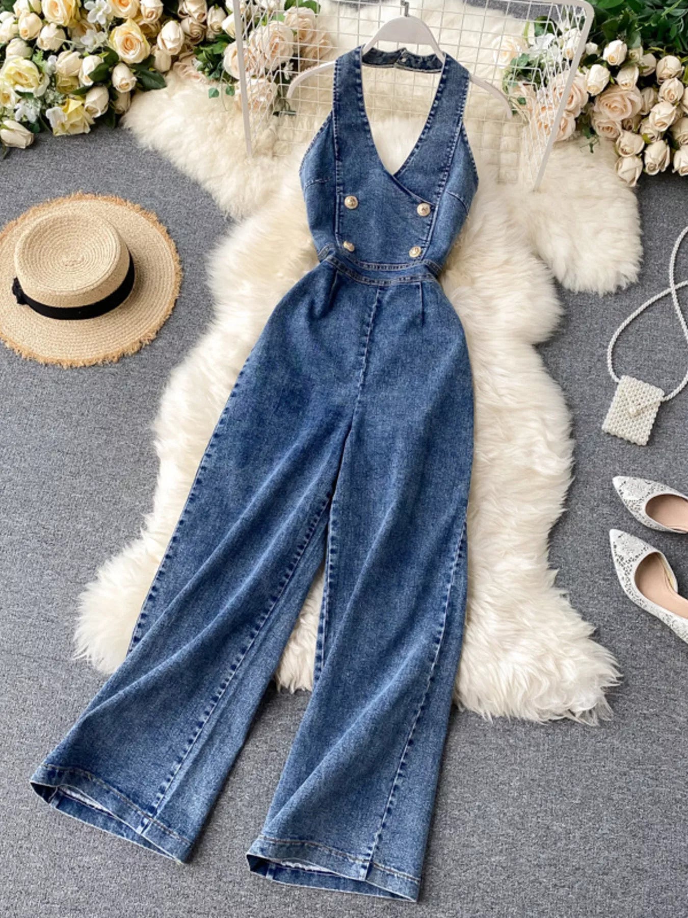 Halter neck wide-leg denim jumpsuit from Trendsi with adjustable straps and front pockets, styled on a model.