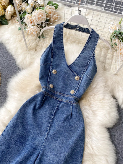Halter neck wide-leg denim jumpsuit by Trendsi, featuring a fitted bodice and flowing wide-leg pants in classic blue denim.