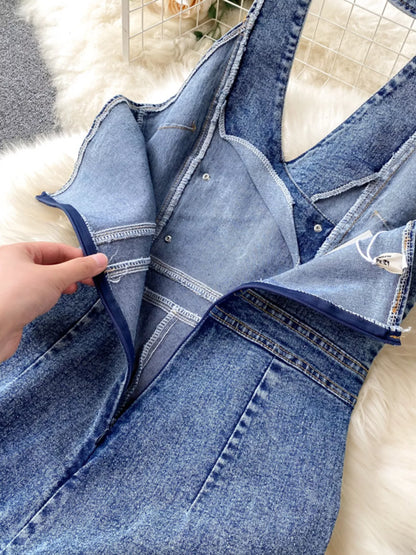 Halter neck wide-leg denim jumpsuit by Trendsi featuring a stylish fit, front pockets, and cropped wide-leg design.