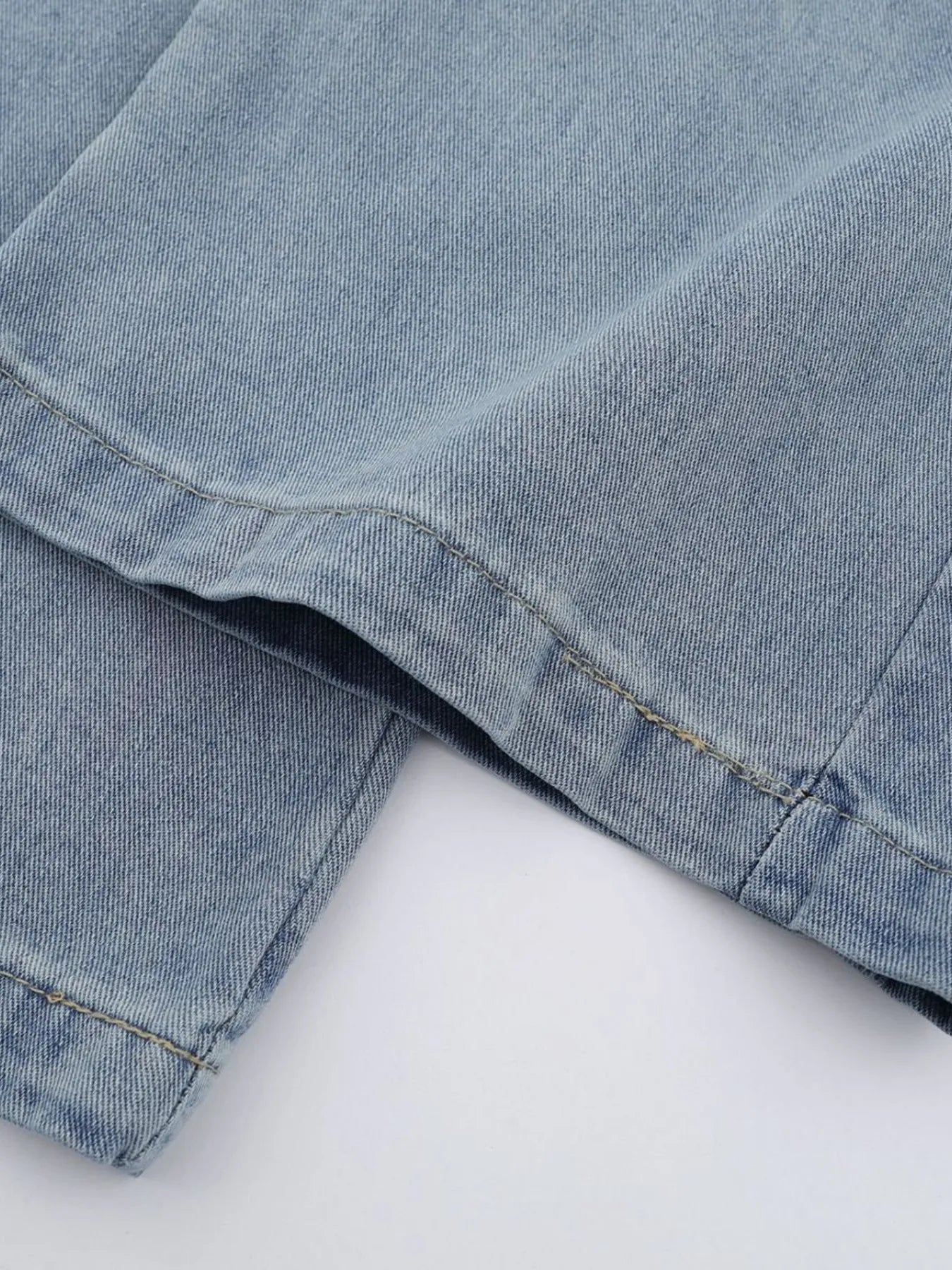 Men's high-waist wide-leg relaxed fit jeans in blue, styled by Trendsi, with visible details of the denim fabric and relaxed silhouette.