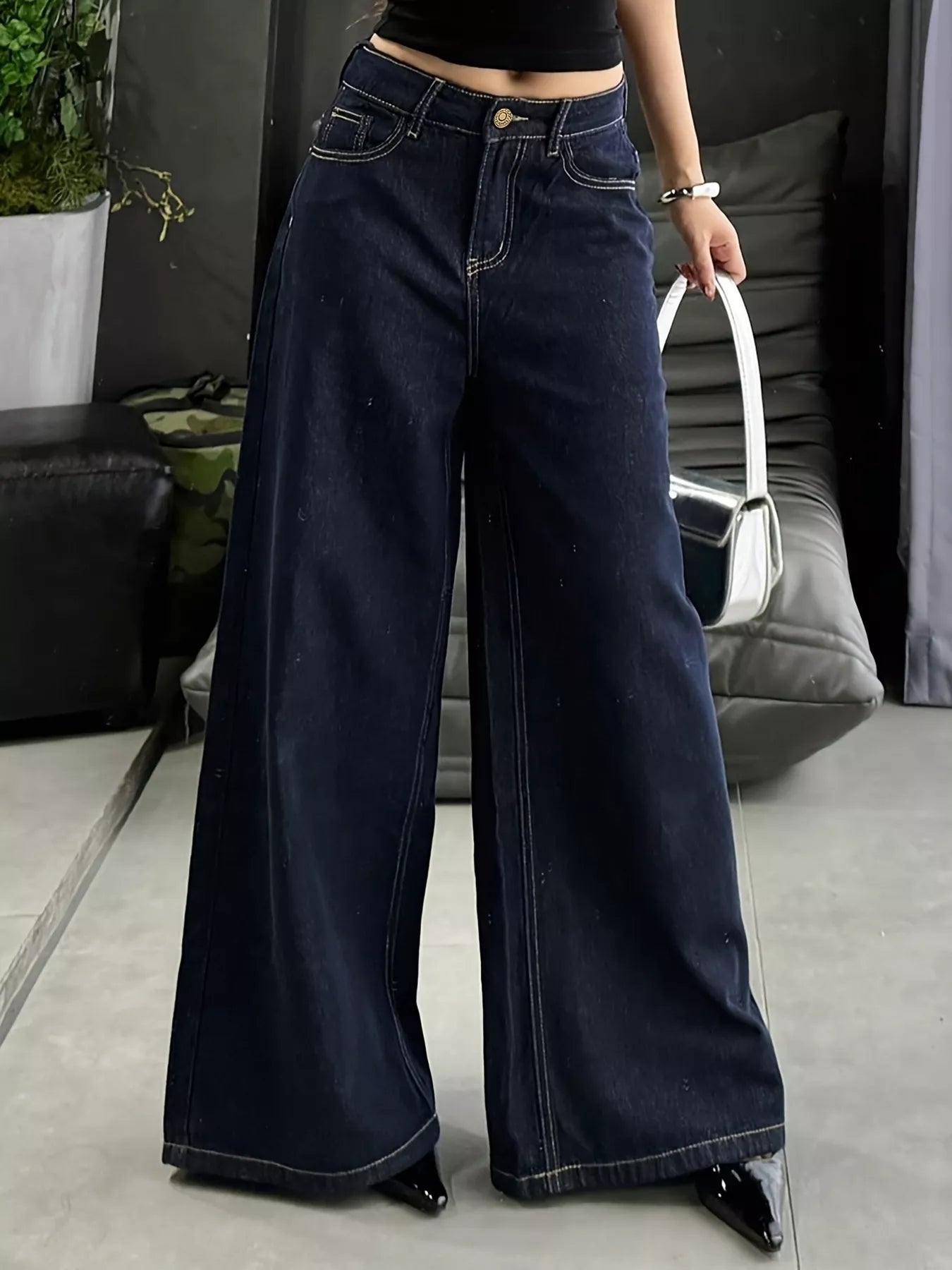 Blue wide-leg jeans from Trendsi featuring a relaxed fit and classic denim design, shown on a model.