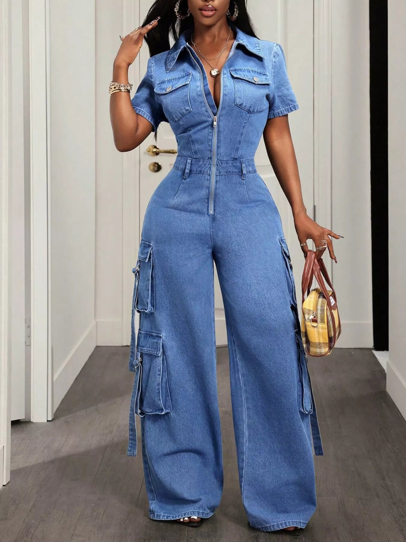Zip front short sleeve denim jumpsuit by Trendsi, featuring a fitted style with functional front zipper and casual short sleeves.
