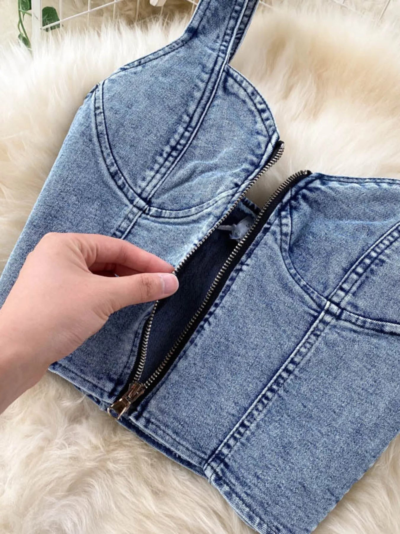 Denim set featuring a zipper top and button slit skirt from Trendsi, shown on a model, with detailed stitching and trendy style.
