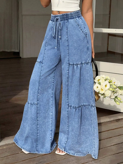 Light blue wide-leg tiered jeans from Trendsi, featuring a relaxed fit and layered design, displayed on a plain background.