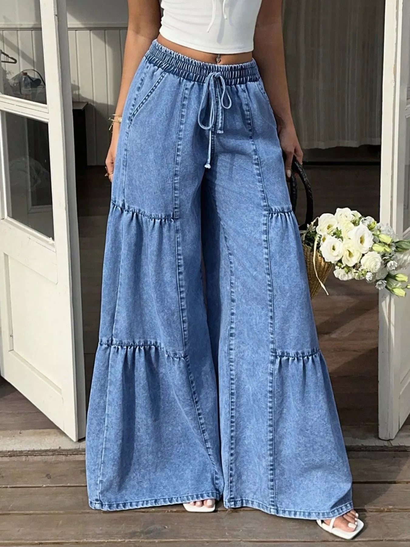 Wide leg tiered jeans by Trendsi featuring a relaxed fit, tiered design, and classic denim wash.