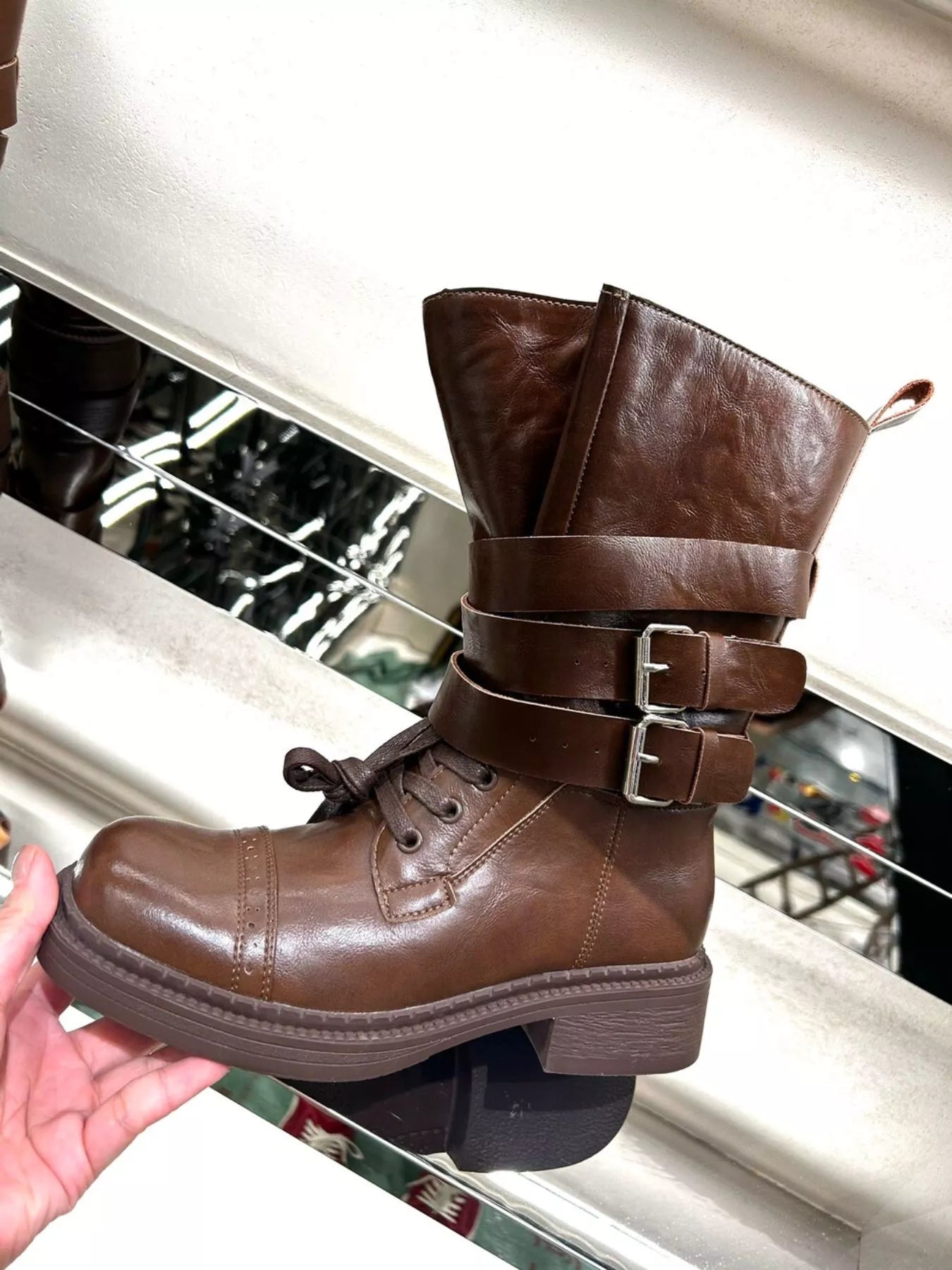 Brown buckled leather block heel boots by Trendsi, featuring a stylish design with buckle accents and sturdy heel.