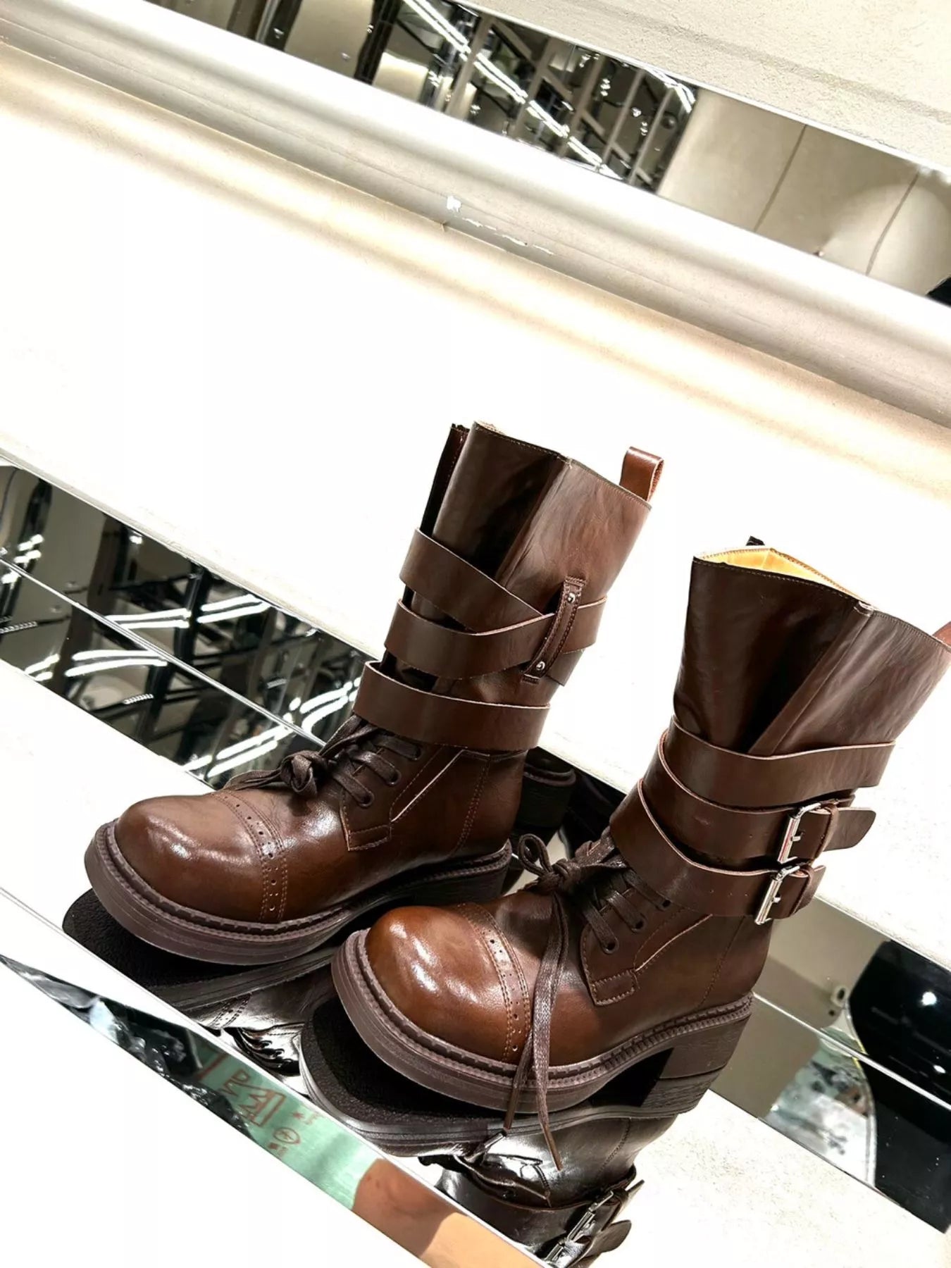 Brown buckled leather block heel boots with ankle straps and stylish design, perfect for trendy fall and winter outfits.