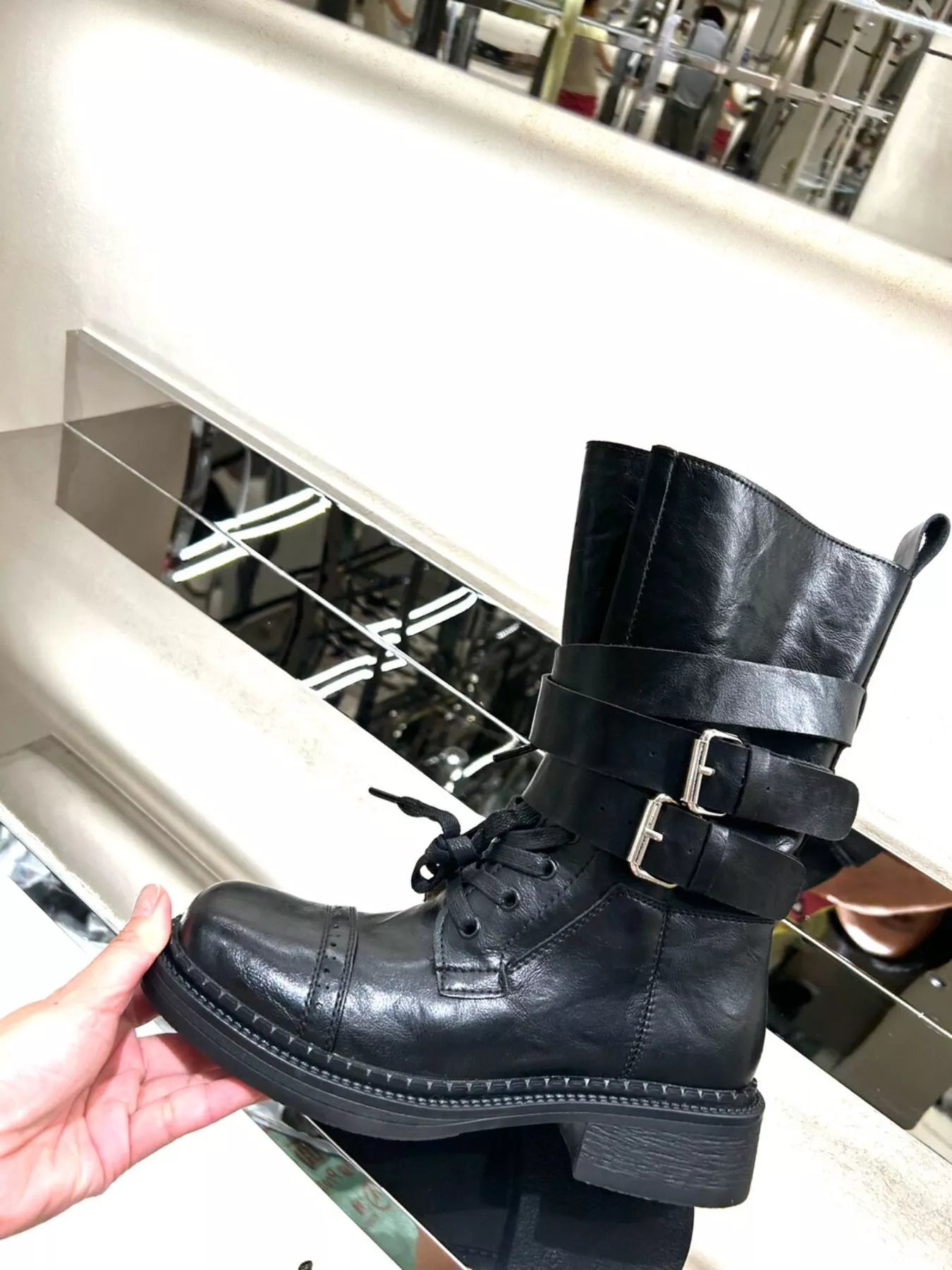 Brown buckled leather block heel boots by Trendsi featuring ankle straps and stylish design on a neutral background.