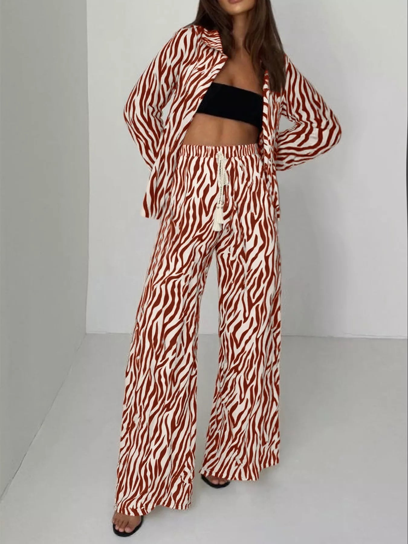 Zebra print relaxed fit top and pants two-piece set by Trendsi, featuring bold animal print and comfortable casual style.
