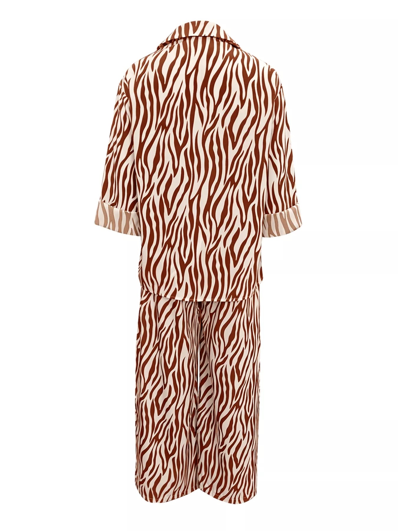 Zebra print relaxed fit top and pants two-piece set by Trendsi, featuring a stylish, comfortable matching outfit with bold black and white pattern.