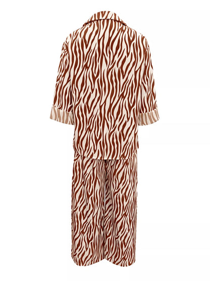 Zebra print relaxed fit top and pants two-piece set by Trendsi, featuring a stylish, comfortable matching outfit with bold black and white pattern.
